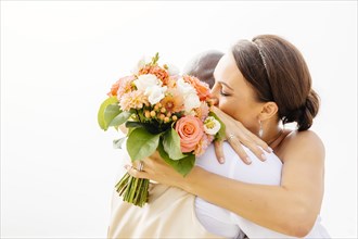 Bride and groom hugging in outdoor wedding