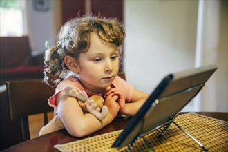 Caucasian girl watching digital tablet