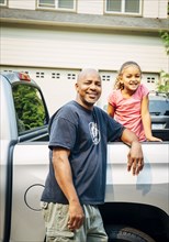 Father and daughter smiling in truck