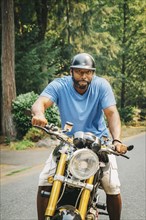 Black man sitting on motorcycle