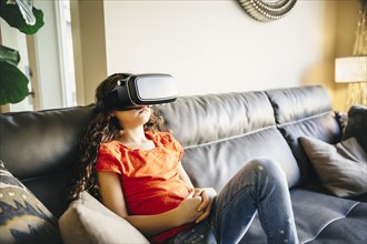 Mixed race girl using virtual reality goggles