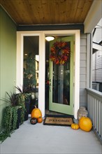 Pumpkins and wreath in doorway