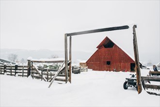 Fence and barn on snowy farm