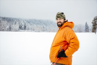 Caucasian man standing in snowy field