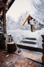 Shed and snowy steps near rural house