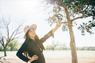 Chinese woman taking selfie in field