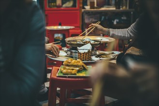 People eating with chopsticks in restaurant