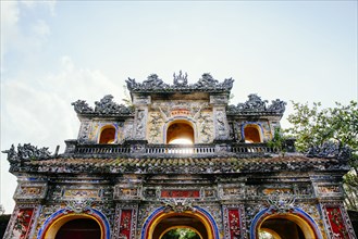 Low angle view of ornate building facade under clouds
