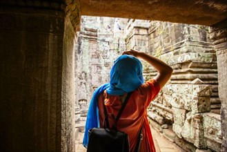 Woman exploring ruins at Angkor Wat