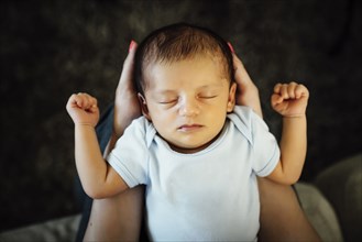 Hispanic woman holding baby boy in lap