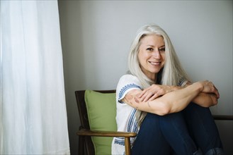 Caucasian woman sitting in armchair