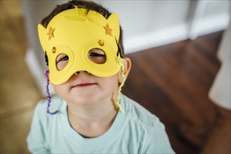 Caucasian boy wearing yellow mask
