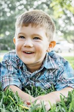Smiling Caucasian boy posing in grass