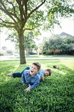 Smiling Caucasian boys playing in grass