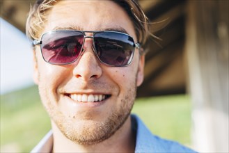 Smiling Caucasian man wearing sunglasses