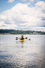 Man and woman in kayak holding paddles