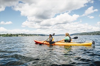 Man and woman paddling kayak