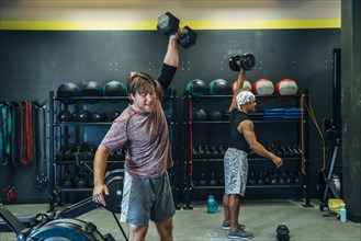 Men lifting weights in gymnasium