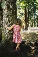 Caucasian girl walking on tree roots