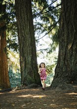 Caucasian girl running in forest