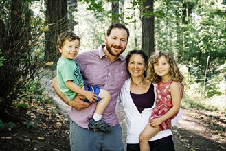 Portrait of smiling Caucasian family in park