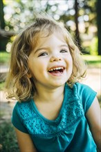 Portrait of laughing Caucasian preschool girl