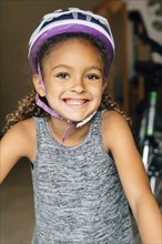 Portrait of smiling Mixed Race girl wearing helmet