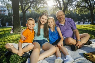 Portrait of smiling Caucasian family in park