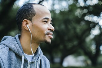 Black man listening to earbuds