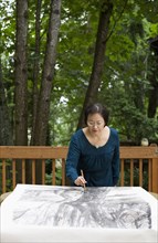 Chinese woman painting outdoors