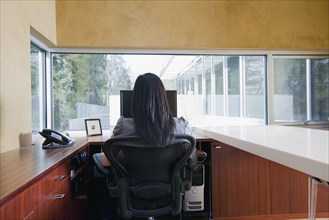 Asian businesswoman sitting at desk