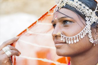Close up of Indian woman wearing traditional jewelry