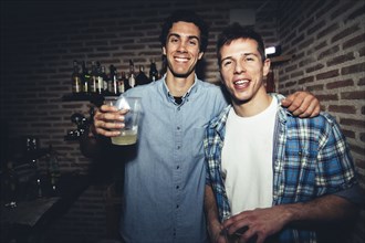 Smiling men drinking in nightclub