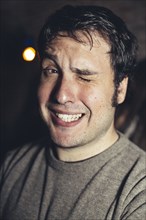 Close up of Hispanic man winking