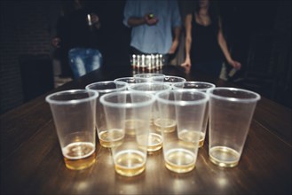 Friends playing beer pong at party