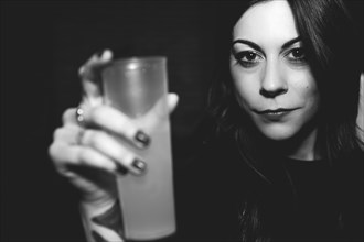 Caucasian woman drinking in nightclub