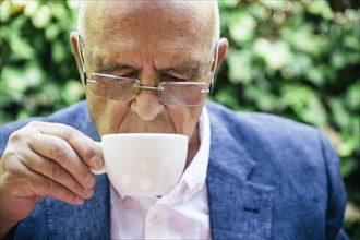 Hispanic businessman drinking cup of coffee