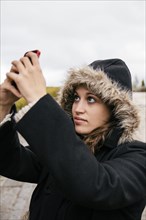 Caucasian woman taking selfie outdoors