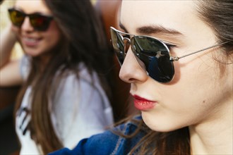 Women wearing sunglasses in car
