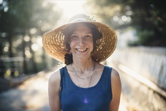 Smiling Caucasian woman wearing sun hat
