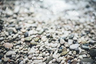 Wet pebbles at beach