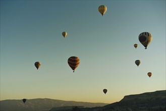 Hot air balloons flying at sunset