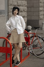 Caucasian woman leaning on bicycle rack
