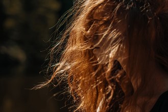 Wind blowing red hair of Caucasian woman