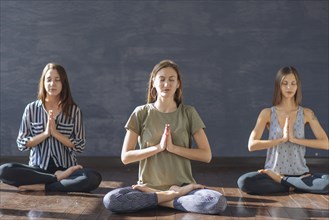 Caucasian women meditating in yoga class