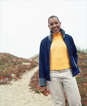 Woman standing on sandy pathway at beach