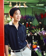 Young man in flower shop