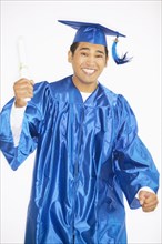 Portrait of teenage boy in cap and gown