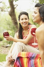 Two young women holding glasses of wine