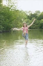 Young woman splashing water